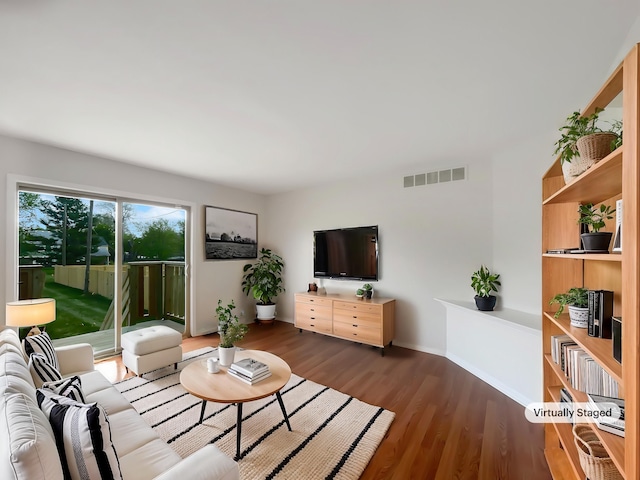 1555 S Harris Rd, Ypsilanti, MI 48198 - living area with baseboards, visible vents, and wood finished floors