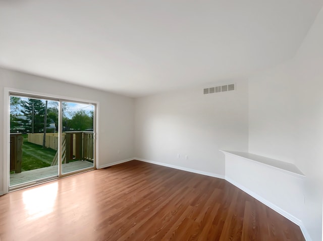 1555 S Harris Rd, Ypsilanti, MI 48198 - spare room with baseboards, visible vents, and wood finished floors