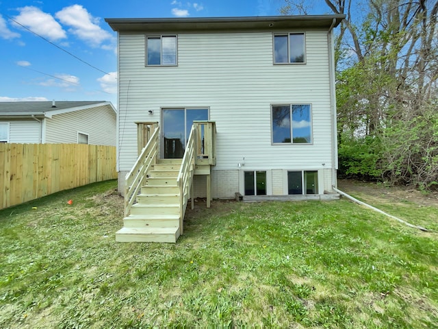 1555 S Harris Rd, Ypsilanti, MI 48198 - rear view of house with fence and a lawn