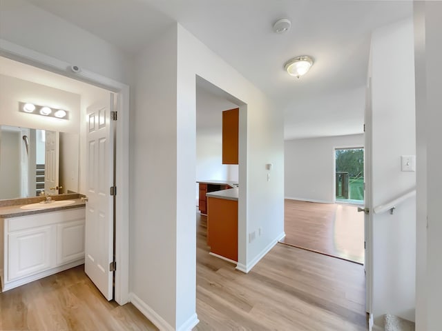 1555 S Harris Rd, Ypsilanti, MI 48198 - hall with a sink, light wood-style flooring, and baseboards