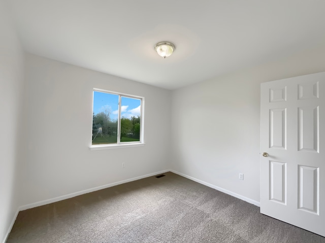 1555 S Harris Rd, Ypsilanti, MI 48198 - unfurnished room with dark colored carpet, baseboards, and visible vents
