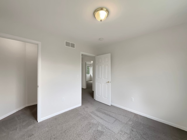 1555 S Harris Rd, Ypsilanti, MI 48198 - unfurnished bedroom featuring carpet floors, baseboards, and visible vents