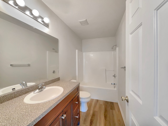 1555 S Harris Rd, Ypsilanti, MI 48198 - full bathroom featuring toilet, wood finished floors, shower / bathing tub combination, visible vents, and vanity