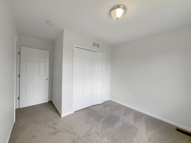 1555 S Harris Rd, Ypsilanti, MI 48198 - unfurnished bedroom with baseboards, visible vents, and carpet floors