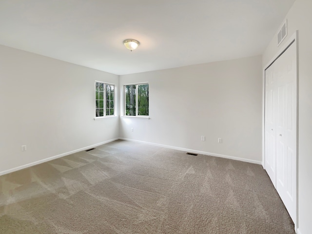1555 S Harris Rd, Ypsilanti, MI 48198 - unfurnished bedroom featuring baseboards, carpet flooring, a closet, and visible vents