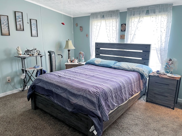 bedroom with carpet flooring, a textured ceiling, crown molding, and baseboards
