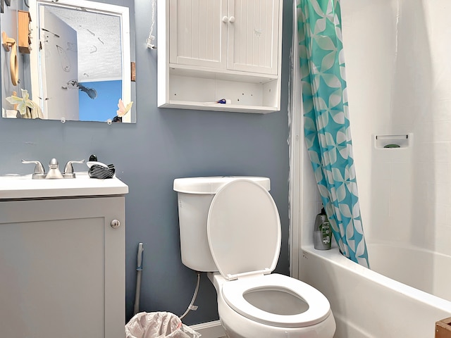 full bath with toilet, shower / tub combo with curtain, and vanity