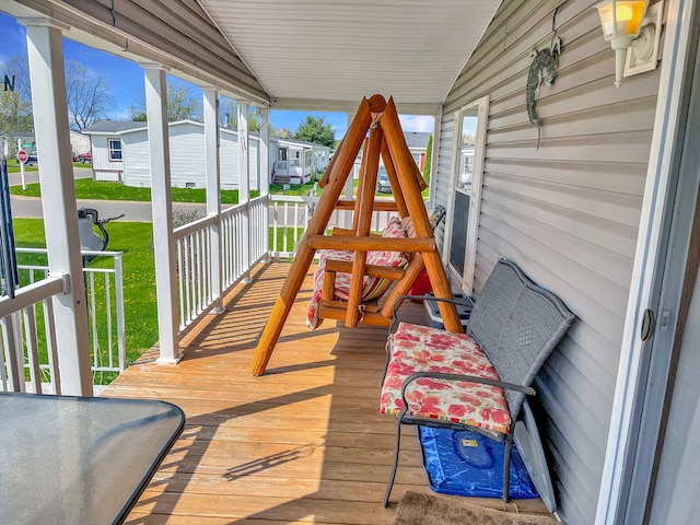 wooden deck with a porch and a residential view