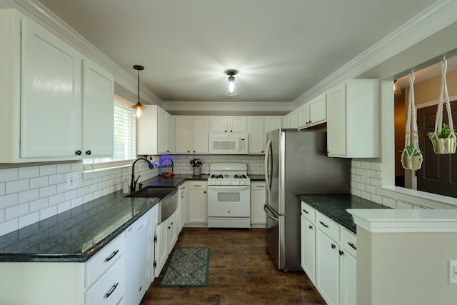 kitchen with white appliances, a sink, white cabinets, decorative backsplash, and dark wood-type flooring