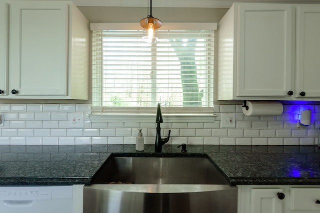 kitchen with a sink, dishwasher, backsplash, and white cabinets