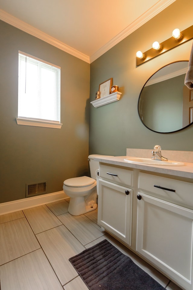 half bath with crown molding, vanity, toilet, and baseboards