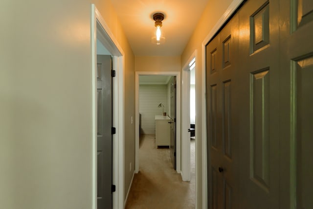 hall with light colored carpet