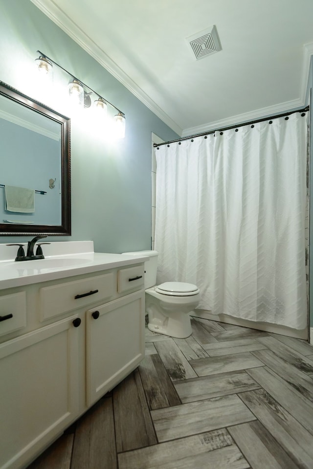 bathroom featuring ornamental molding, vanity, toilet, and curtained shower