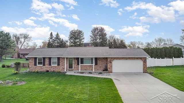 ranch-style home with a garage, fence, concrete driveway, a front lawn, and brick siding