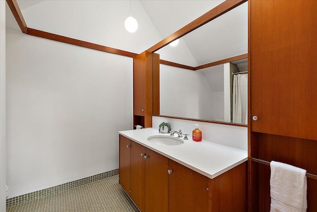 full bath with vanity and lofted ceiling