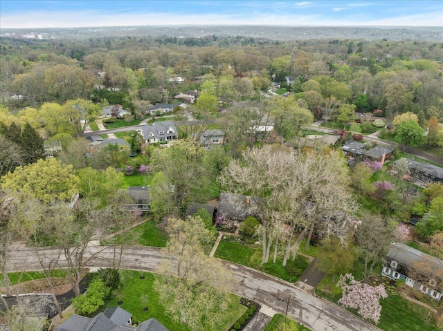 birds eye view of property featuring a view of trees and a residential view