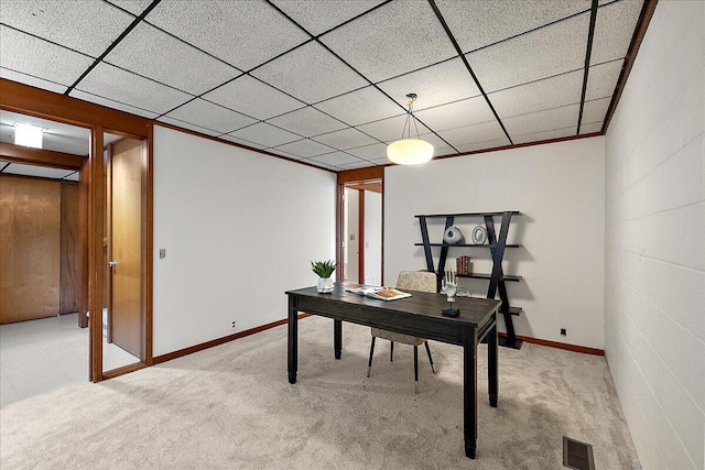 office area with visible vents, baseboards, and light carpet