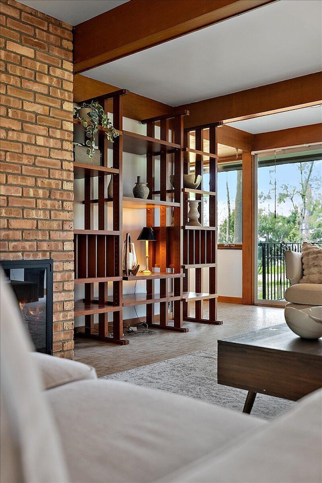 living area with a fireplace and carpet flooring