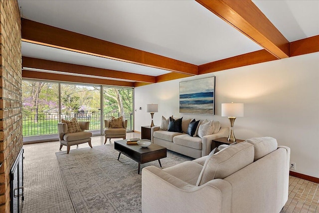 carpeted living room with a brick fireplace, baseboards, and beam ceiling