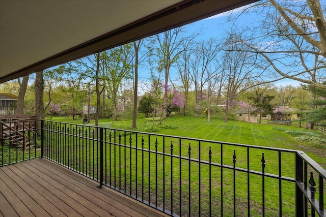 wooden deck featuring a lawn