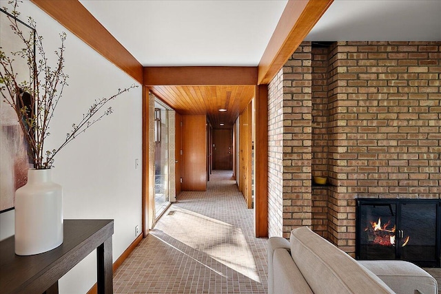 hallway featuring carpet floors and baseboards