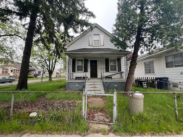 75 Abbott St, River Rouge, MI 48218 - view of front of house featuring a porch, a fenced front yard, and a gate