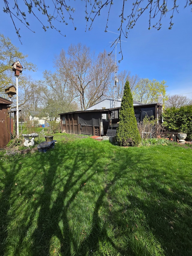 view of yard featuring a sunroom