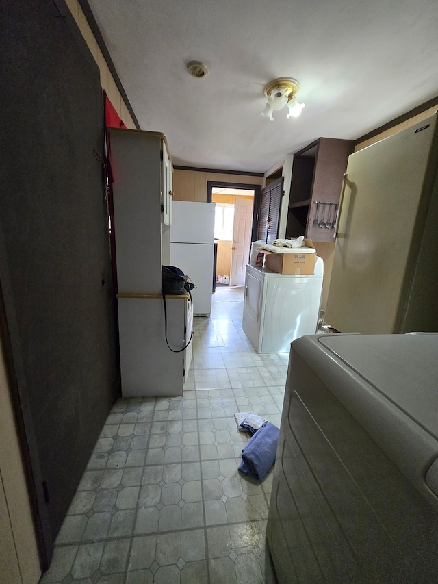laundry area featuring light tile patterned floors, washer / dryer, and laundry area