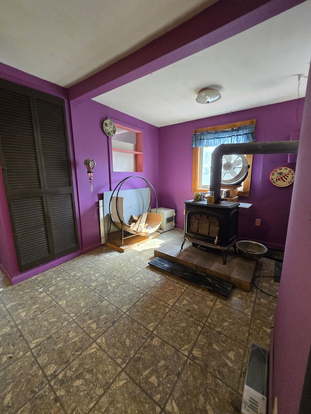 bedroom featuring a wood stove