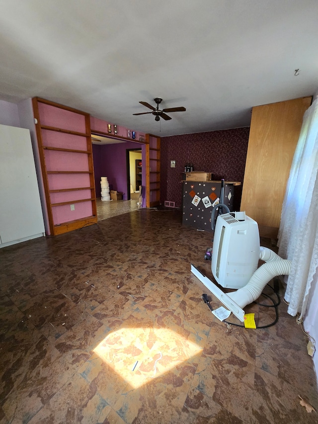 interior space with a ceiling fan and visible vents