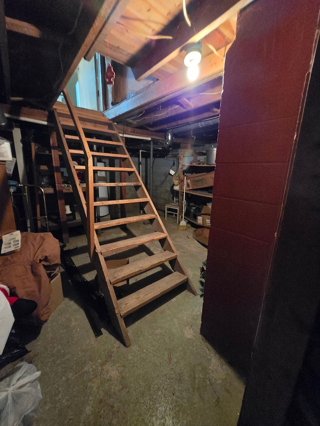 unfinished basement featuring stairway