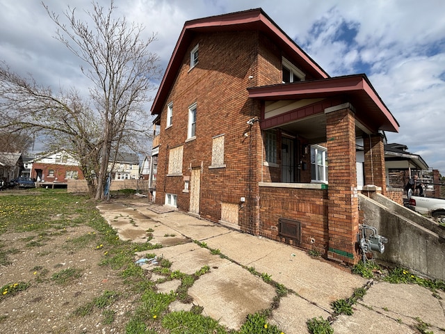view of side of property with brick siding