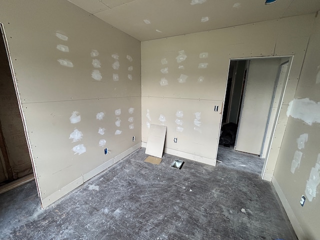spare room with baseboards