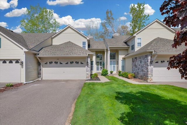 863 Calpernia, Wixom, MI 48393 - view of front of home with a front yard, roof with shingles, asphalt driveway, an attached garage, and stone siding