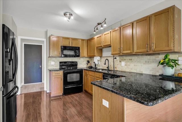 863 Calpernia, Wixom, MI 48393 - kitchen with black appliances, a sink, a peninsula, dark stone countertops, and dark wood-type flooring