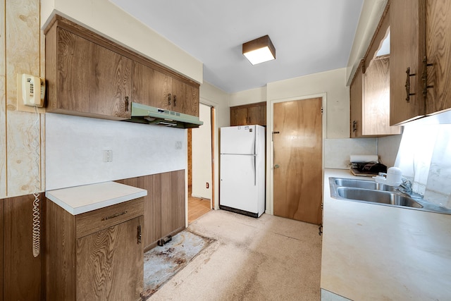 23022 Lexington Ave, Eastpointe, MI 48021 - kitchen with a sink, brown cabinets, freestanding refrigerator, under cabinet range hood, and light countertops