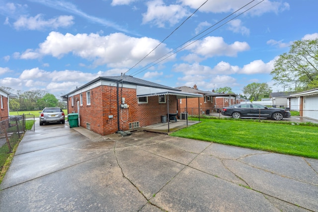 23022 Lexington Ave, Eastpointe, MI 48021 - exterior space featuring a lawn, driveway, brick siding, and fence