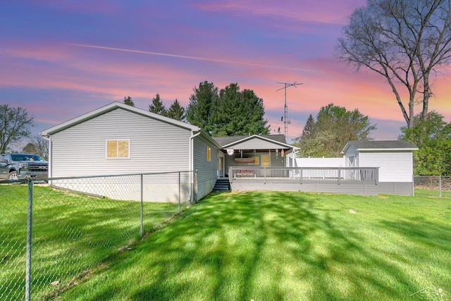 view of yard with an outbuilding, a shed, and a wooden deck