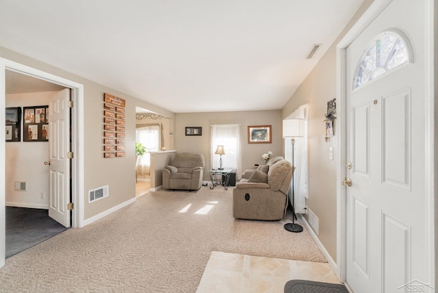 carpeted entrance foyer featuring baseboards