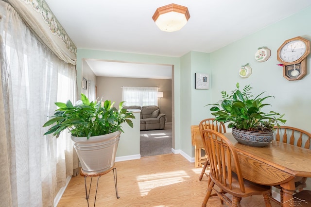hallway with light wood-style floors and baseboards