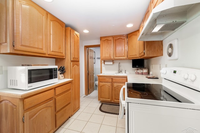 kitchen featuring white appliances, light tile patterned floors, light countertops, recessed lighting, and under cabinet range hood