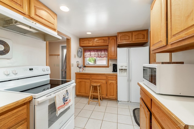 kitchen featuring white appliances, under cabinet range hood, light tile patterned flooring, light countertops, and recessed lighting