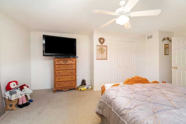 bedroom featuring carpet floors, a closet, ceiling fan, and baseboards