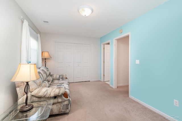 sitting room featuring carpet and baseboards