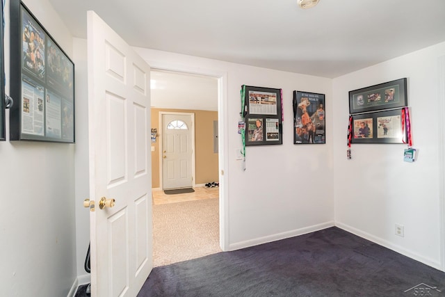 unfurnished room featuring carpet floors, baseboards, and a smoke detector
