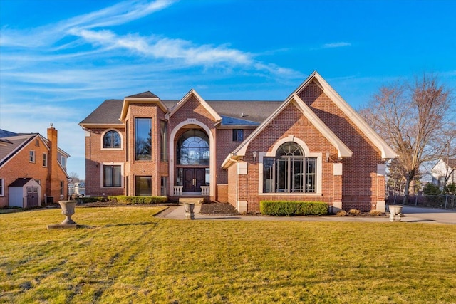 traditional home featuring brick siding and a front yard