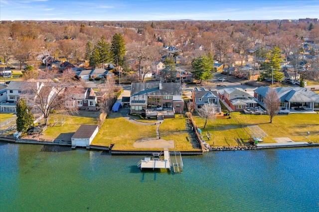 drone / aerial view with a water view and a residential view