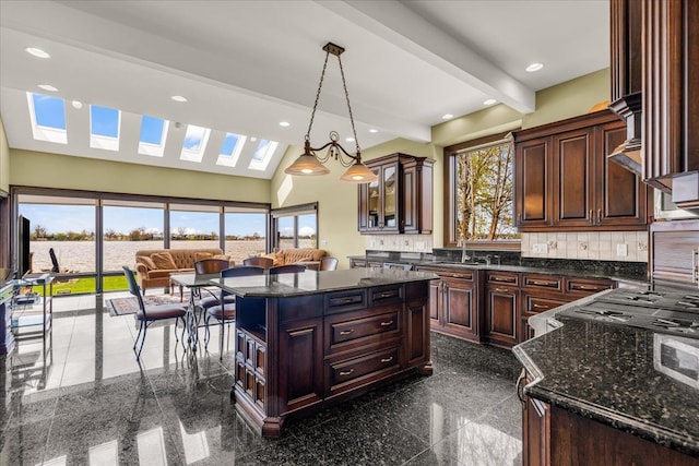 kitchen featuring recessed lighting, decorative backsplash, hanging light fixtures, and granite finish floor