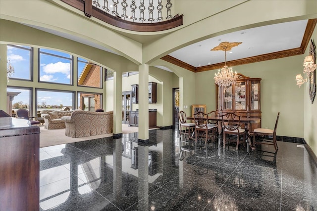 dining space featuring baseboards, an inviting chandelier, granite finish floor, and arched walkways