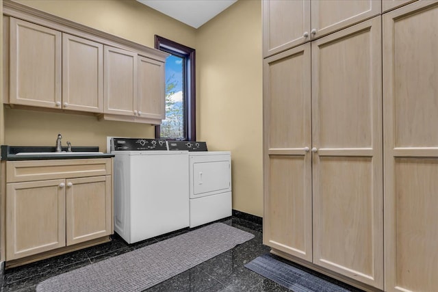 washroom featuring a sink, cabinet space, washing machine and clothes dryer, granite finish floor, and baseboards